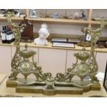 A pair of French bronze chenets, 19th century, with ornate decoration and cherub cartouche,