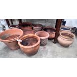 Ten assorted terracotta garden planters, largest diameter 43cm