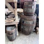 Three iron bound staved wood barrels, largest height 98cm