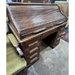 A 1920's oak roll top oak desk with S shaped tambour, width 121cm, depth 65cm, height 114cm