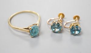 A pair of yellow metal and blue zircon ear clips and a yellow metal and paste set ring, gross weight