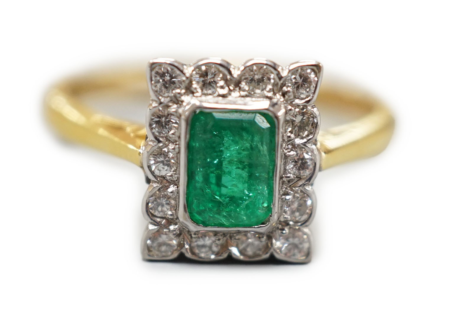 A modern 18ct gold, emerald and diamond set rectangular cluster ring, size N, gross weight 3.4