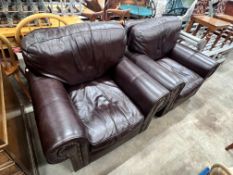 A pair of contemporary studded brown leather armchairs, width 98cm, depth 84cm, height 80cm