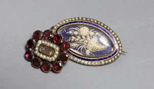 A Victorian yellow metal, garnet and seed pearl set mourning brooch, with plaited hair below a