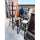 A set of four industrial style painted wrought iron bar stools with circular wooden seats, height