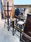 A set of four industrial style painted wrought iron bar stools with circular wooden seats, height