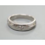 A modern platinum and gypsy set solitaire diamond ring, size K, 6.6 grams.