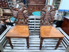 A pair of Victorian carved oak hall chairs with carved twin eagle backs, width 44cm, depth 40cm,