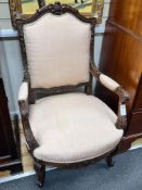 A pair of early 20th century carved walnut upholstered open armchairs, width 67cm, depth 57cm,