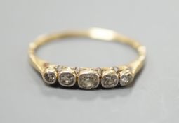 A yellow metal and graduated collet set five stone diamond half hoop ring, size O, gross weight 1.
