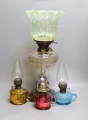 A Victorian oil lamp with vaseline glass shade and three small oil lamps,large oil lamp 49 cms