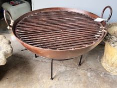 A wrought iron circular fire pit on low stand, diameter 61cm, height 46cm