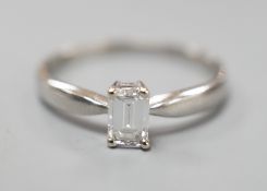 A modern platinum and solitaire emerald cut diamond set ring, size P/Q, gross weight 3.2 grams,
