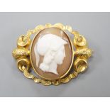 An early 20th century yellow metal mounted oval cameo shell brooch, carved with with the bust of a