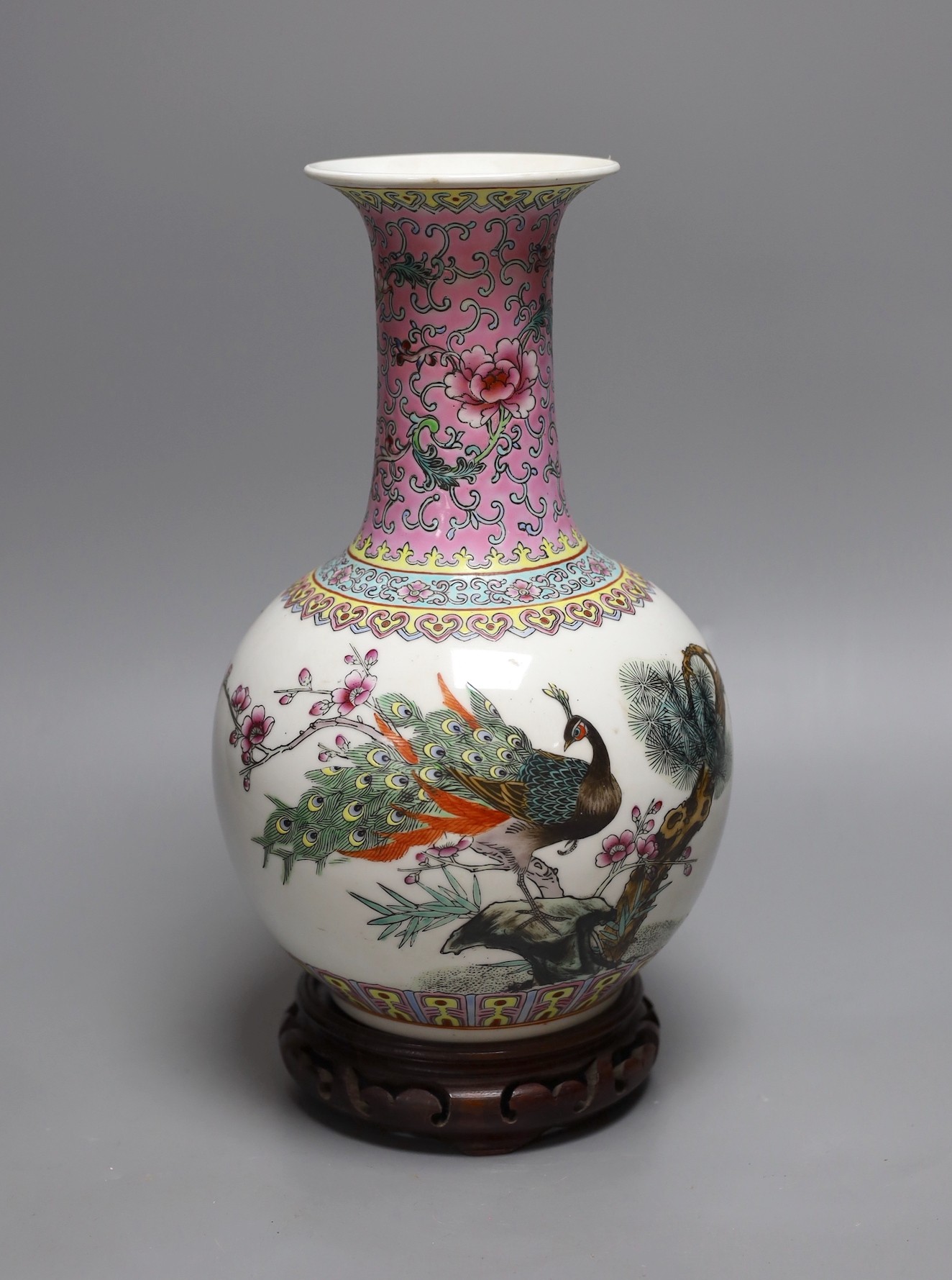 A Chinese famille rose vase, 27cm, on carved wood stand