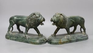 A pair of carved green serpentine models of lions rampant,24 cms wide,