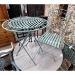 A circular painted folding garden table, diameter 69cm, height 76cm and two folding chairs