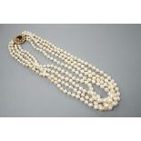 A 1960's triple strand cultured pearl necklace, with garnet and seed pearl set 9ct gold clasp,