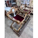 A pair of Renaissance style giltwood and composition X frame elbow chairs, on lion's paw feet, width