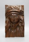 A carved oak figural appliqué,28.5 cms high,