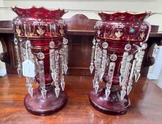 A pair of Victorian ruby glass table lustres,36 cms high,