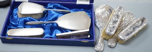 A cae 1970's engine turned silver mounted four piece mirror and brush set, two silver mounted hand