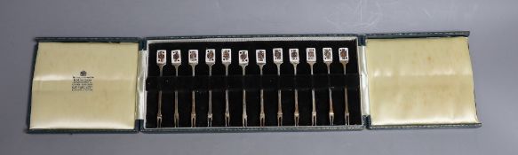 A cased set of twelve early 1960's silver and enamel cocktail sticks, by Garrard & Co, with