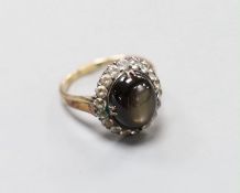 A 14k yellow metal, star sapphire and white sapphire? set oval cluster ring, size N, gross weight