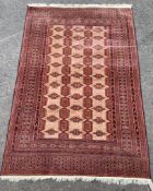 A Bokhara pale red ground rug, 185 x 122cm