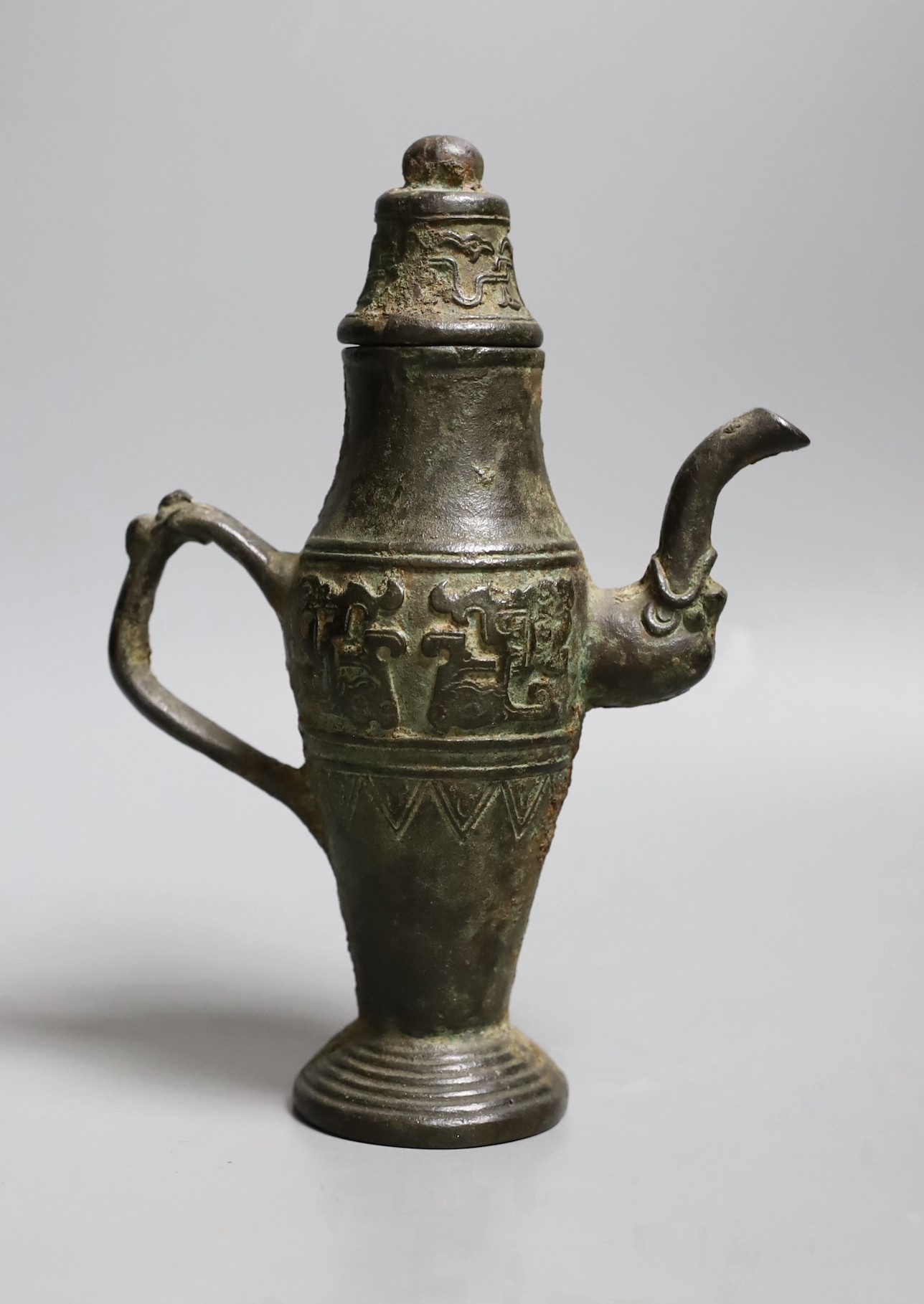 A Chinese archaistic bronze pouring vessel and cover, 17th/18th century,22cms high,