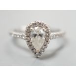 A modern '77 Diamonds' 18ct white gold and singe stone pear cut diamond set ring bordered with