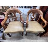 A pair of Victorian walnut elbow chairs with light brown leather seats, width 59cm, depth 51cm,
