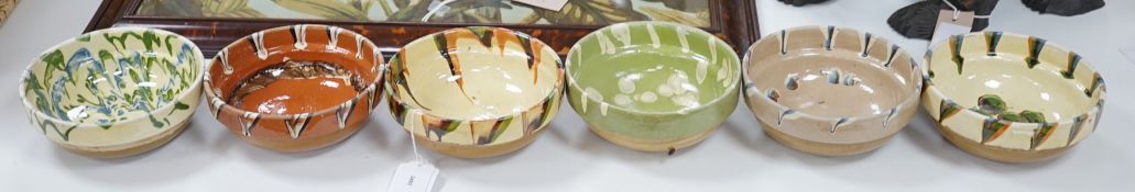 A group of six continental pottery slip decorated bowls,16 cms diameter,