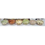 A group of six continental pottery slip decorated bowls,16 cms diameter,