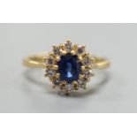 A modern 18ct gold, sapphire and diamond set oval cluster ring, size L, gross weight 3.8 grams,