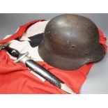 A Third Reich SS dagger, German steel helmet and a Nazi flag