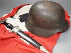 A Third Reich SS dagger, German steel helmet and a Nazi flag