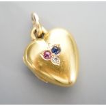 An Edwardian 15ct, sapphire, diamond and ruby set heart shaped locket, 17mm, gross weight 5.7