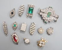 A small group of assorted white or base metal and paste set clasps.