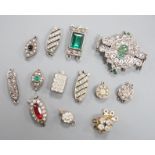 A small group of assorted white or base metal and paste set clasps.