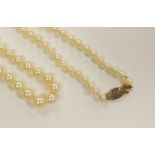 A single strand graduated cultured pearl necklace, with rose cut diamond set yellow metal clasp,