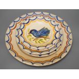 Five Portuguese provincial pottery plates,largest 35 cms diameter,