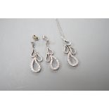 A modern white metal and diamond set quadruple teardrop shaped cluster drop pendant, 28mm, on a