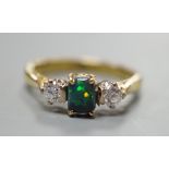 A modern 18ct gold, black opal and diamond set three stone ring, size Q, gross weight 4.6 grams, the
