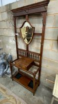 A late Victorian mahogany hall stand with shield silvered mirror, width 84cm, height 203cm