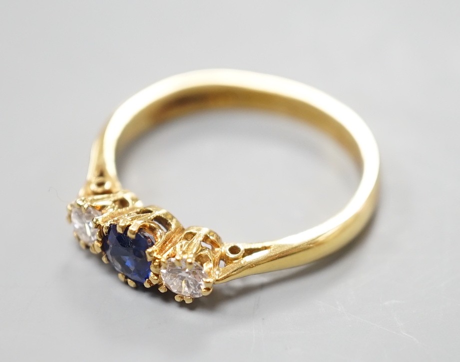 A modern 18ct gold, sapphire and diamond set three stone ring, size S, gross weight 4.4 grams, the - Image 2 of 4