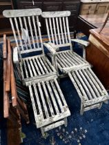 A pair of weathered teak garden steamer chairs and three Sou-wester teak deckchairs
