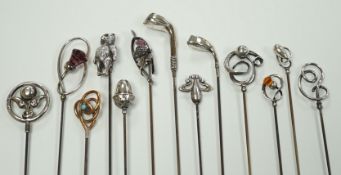A collection of thirteen assorted early 20th century and later white or yellow metal hat pins,