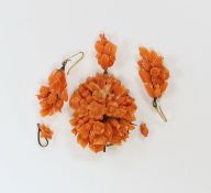 A late 19th/early 20th century gilt metal mounted drop pendant coral brooch carved as a bouquet of