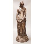 After Boisseau, a tall bronzed metal figure of a standing maiden, signed to verso, 58cm tall